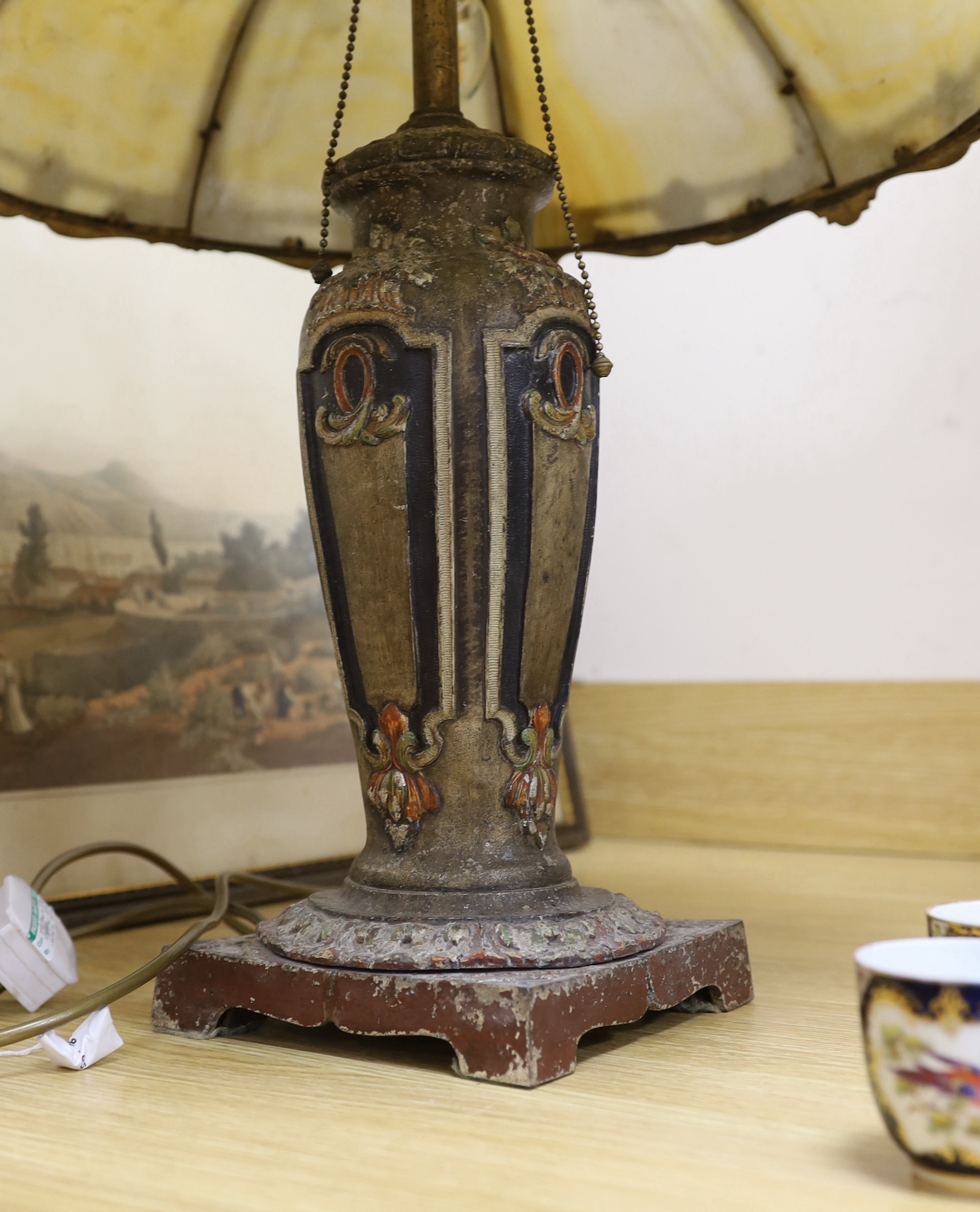 An early 20th century American ‘Miller & Co’ painted spelter and opaque glass table lamp, 55cms high